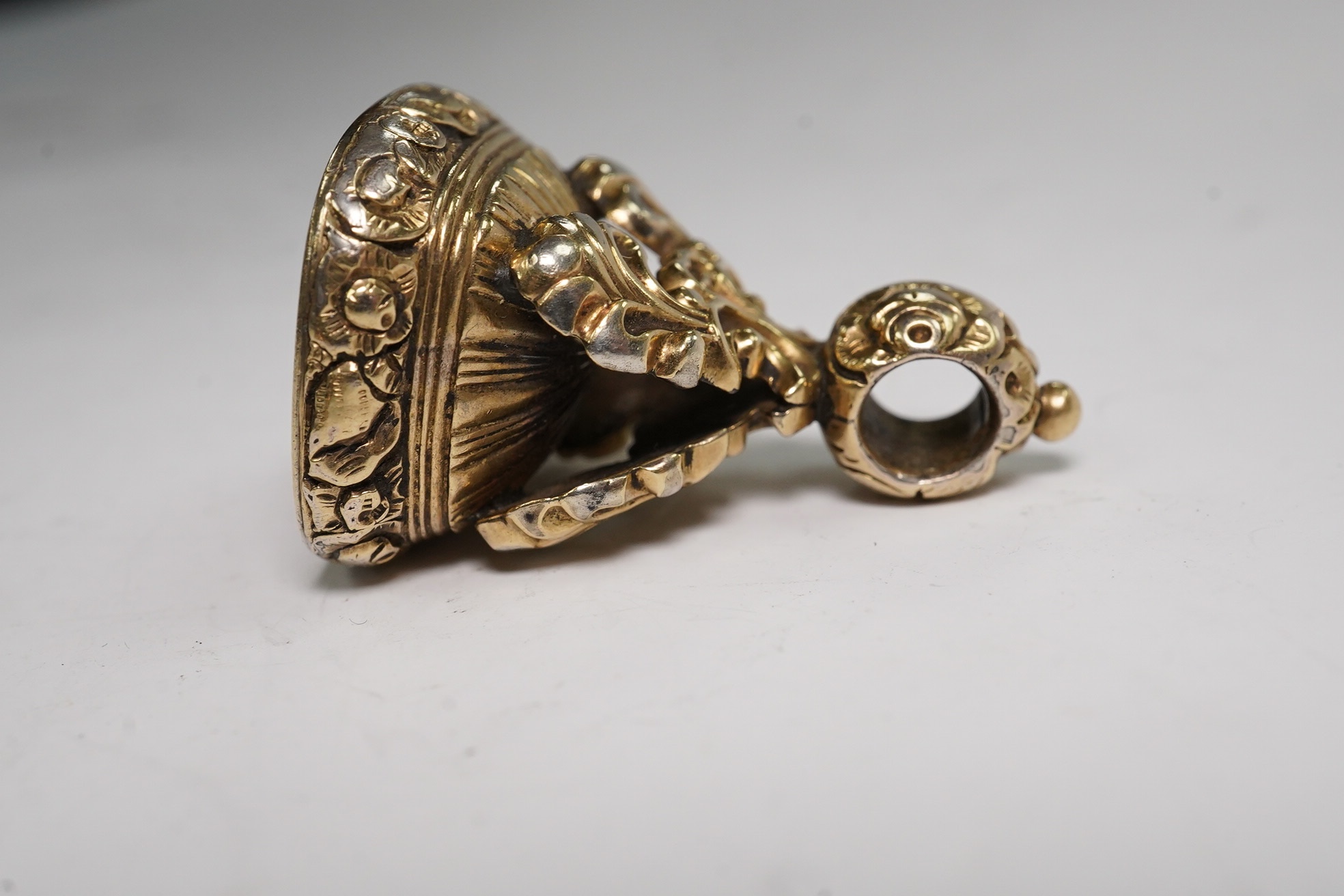 An early 20th century gold, carnelian and bloodstone set spinning fob, 34mm and one other gilt metal and carnelian set fob. Condition - poor to fair